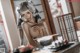 A woman sitting at a table with a bowl of food.