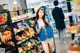 A woman standing in front of a shelf of snacks.